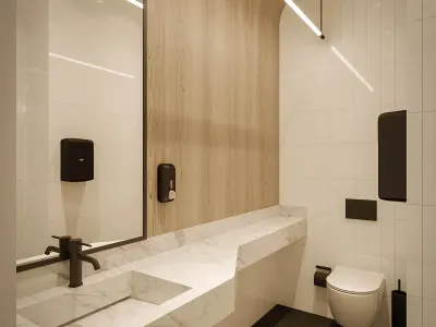 Tüm ziyaretçilerimizin ve çalışanlarımızın konforla erişebileceği stratejik noktalarda kurguladığımız tuvaletleri; modern minimalist tasarım anlayışı, dingin renk paletleri ve yüksek işlevsellikle her kata entegre etmiş bulunuyoruz. Sürdürülebilirlik ilkelerimiz doğrultusunda bu ıslak hacimlerde su tasarrufu sağlayan vitrifiye ürünleri ile enerji verimli sarkıt aydınlatma ve armatür tercihleri yaptık. Yoğun sirkülasyon akışına sahip bu ortak alanlarda, güçlü mekanik havalandırma sistemleri ve kolay dezenfekte edilebilir yüzey kaplamaları kullanarak kusursuz bir hijyen ve ergonomi dengesi kurmuş oluyoruz. Bu projede ofis iç tasarım disiplininin gerekliliklerini en üst düzeyde yansıttık.