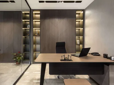 During the professional interior design process of this office, we curated this workspace with a refined and functional design language. While the geometric wooden panels we preferred on the partition wall surfaces bring a contemporary character to the space, the LED light bands integrated into the open shelves enhance the architectural details, creating aesthetic depth. The executive desk becomes the focal point of the room with its minimal lines and elegant detail solutions. The large-format porcelain ceramic surfaces we used for flooring enlarge the space, providing a spacious and luminous atmosphere. With our furniture selection reflecting the corporate identity and our sophisticated color palette, we design prestigious spaces that combine the dynamism of the business world with comfort.